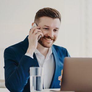 young-stylish-executive-talking-on-phone-in-front-NRNJ7T3.jpg